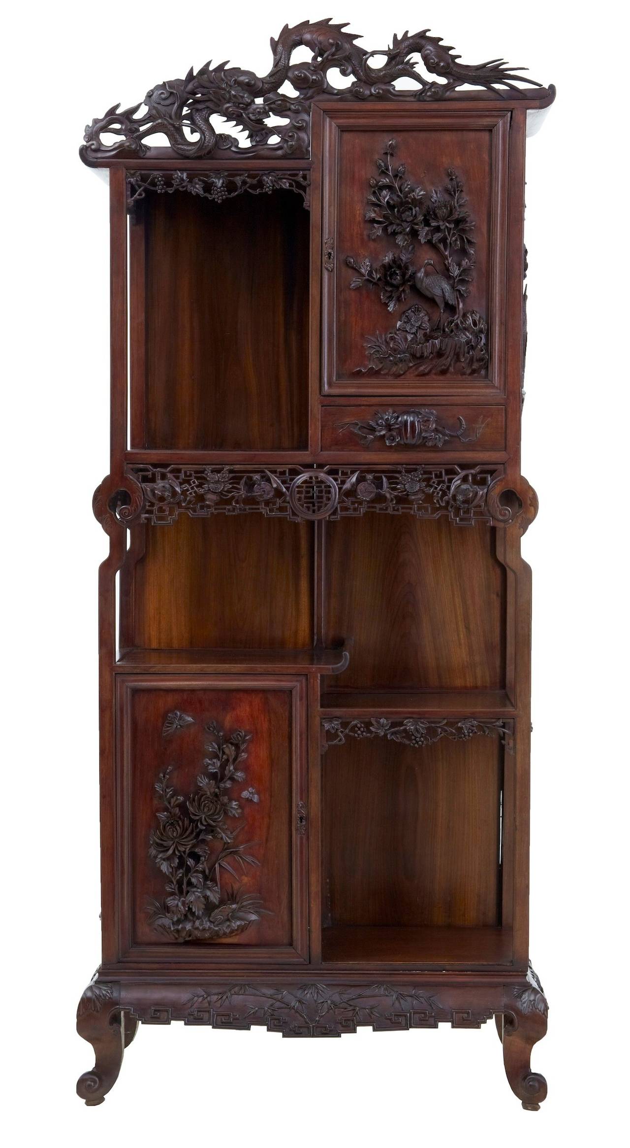 Stunning profusely carved Chinese cabinet circa 1890. 
Beautiful cabinet consisting of three main levels. Top level with open display to the left and a single door cupboard to the right with drawer below. Deep carving on the door depicts a crane