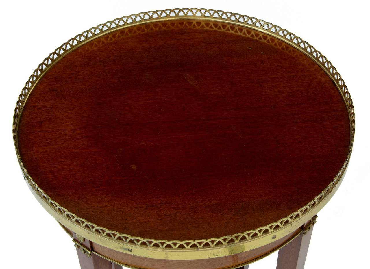 Good quality Empire style occasional lamp table, circa 1930. 
Stamped by makers-retailers mark a.B Nordiska Kompaniet. 
Round top with pierced brass gallery. Further brass mounts to sides and legs.

Measures: Height 30 1/2