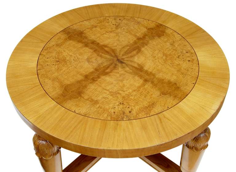 Art Deco Swedish carved birch and elm coffee table.
Crossbanded with birch and central elm veneer Swedish coffee table, circa 1930s
Standing on carved legs united by a X-frame stretcher.
Measures: Height 22 1/2