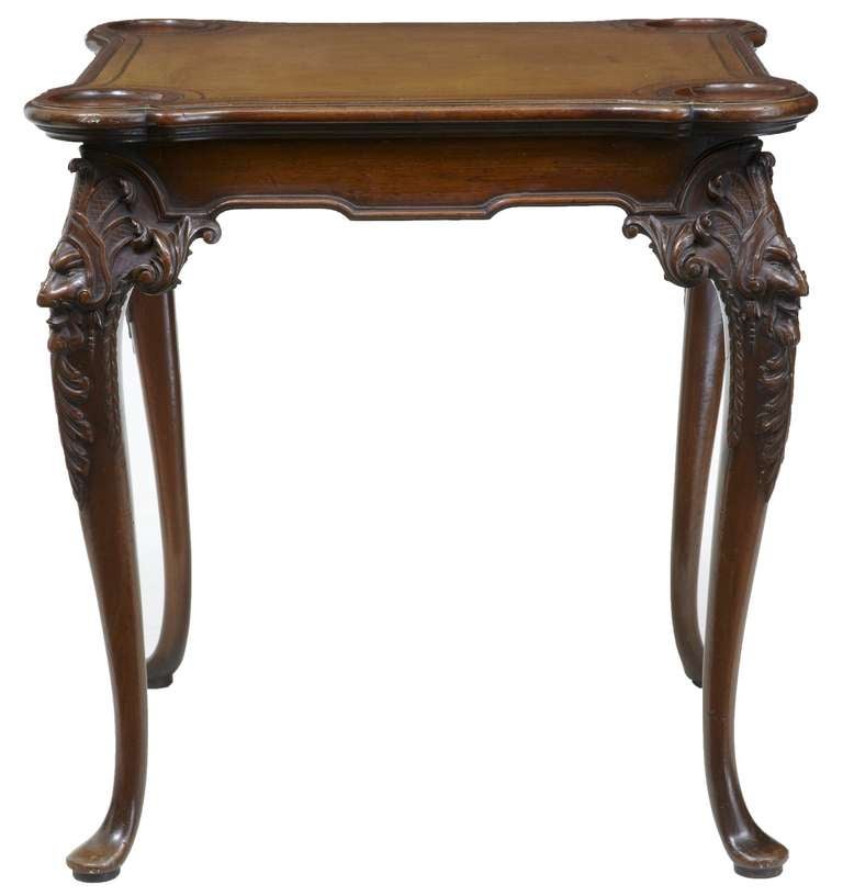 Beautifully Coloured Table Featuring Shaped Leather Top And Dished Corners. 

Carved Face To Each Leg Standing On Pad Foot 

Leather Has A Crease Which Doesnt Detract Too Much, But It Is The Original Leather. (see Photo) 

Height: 30