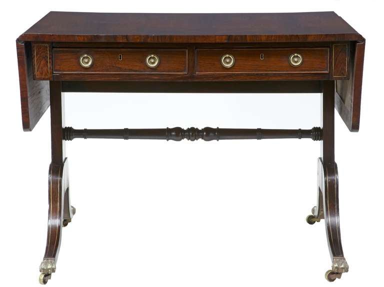 A fine two-drawer rosewood sofa table of good color, brass stringing to top, legs and sides.

Original castors and dummy drawers to reverse. 

Measure: Height 28