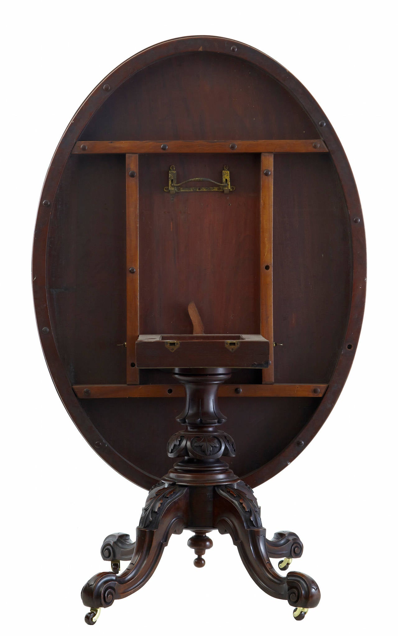 Oval tilt top loo table circa 1880.
Walnut oval top, with tilting ability and brake.  Standing on a carved central stem quadriform base.
Replaced castors.

HEIGHT: 29 3/4
