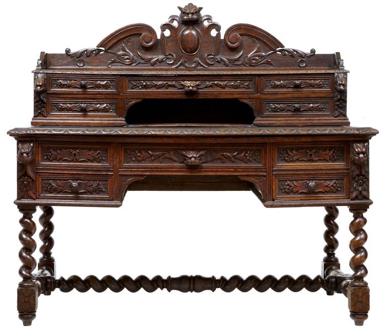 Fine quality carved oak library desk circa 1880 

Consisting of two parts. Top section contains five drawers and an open storage area, with shelf surface to the top. Baize covered writing area pulls forward (not photographed). The bottom section