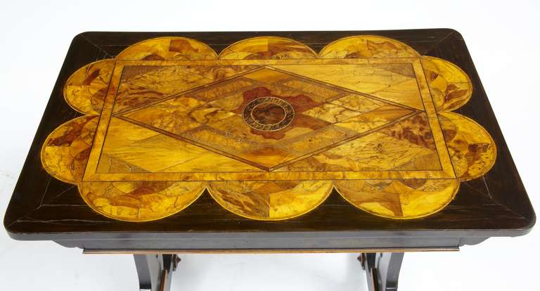 
A rare Regency calamander and specimen wood sofa table

Here we present a stunning and rare table

The rectangular Ceylonese top inlaid with a geometric design of lozenges, ellipses and other shapes in various exotic specimen woods above a