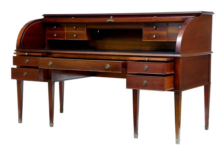 Large 1920s mahogany roll top desk writing table


This desks is large and heavy and would have been commissioned by a hotel or business.

Made as one-piece the roll top reveals a bank of 2 drawers each side and a black leather writing surface