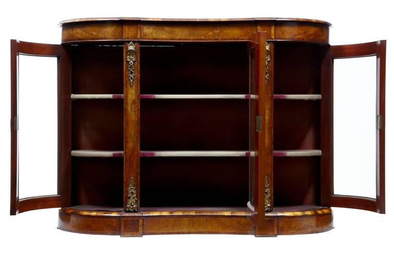 Excellent quality walnut credenza, circa 1870. 

Beautiful color and patina, ormolu mounts. 

Original glazing and faded velvet interior.

Measures: Height: 40 1/4