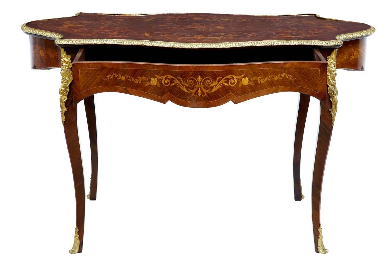Stunning quality inlaid table, circa 1880. 

Inlaid with various woods such as satinwood and kingwood, this table has a stunning top, ormolu surround to the top and mounts to the legs and feet. 

Single drawer deep drawer to the front, inlaid to