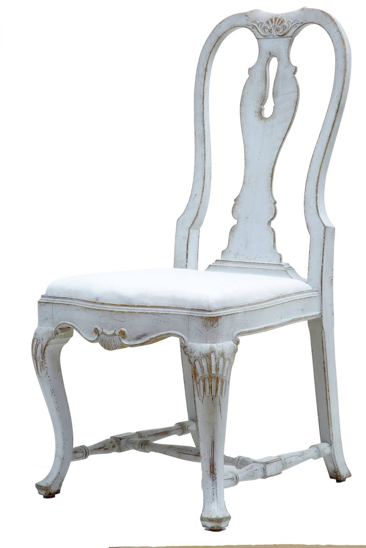 Stunning large rare set of 12 queen anne influenced dining chairs circa 1880. 

Carving to the backs, knees and stylised shells on the front rail. Standing on a pad foot to the front. 

Upholstered in calico ready to be covered in a fabric of