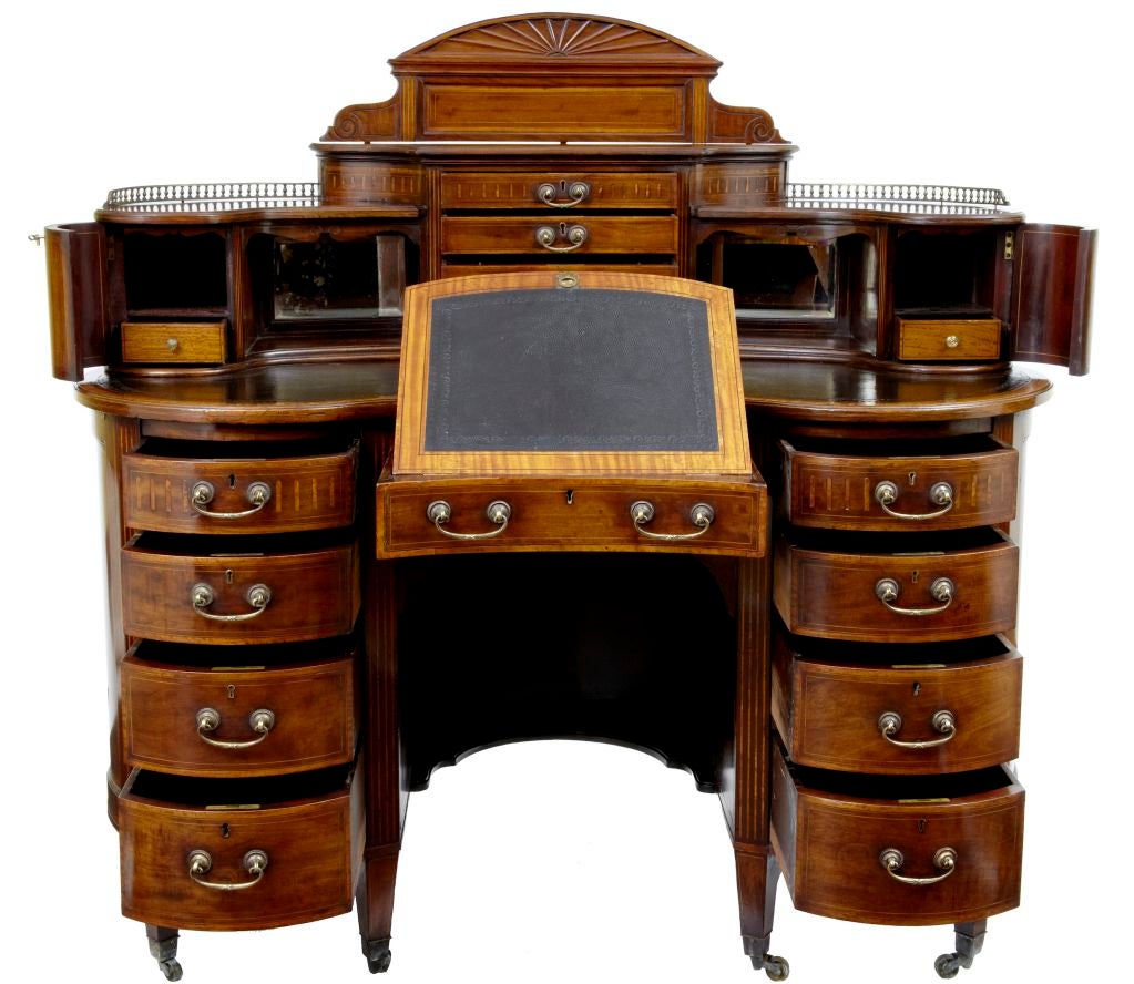 19TH CENTURY MAHOGANY KIDNEY SHAPED DESK CIRCA 1890<br />
<br />
INLAID WITH SATINWOOD AND BOXWOOD, FITTED INTERIOR WITH A WRITING SLOPE IN THE DRAWER, BLACK LEATHER