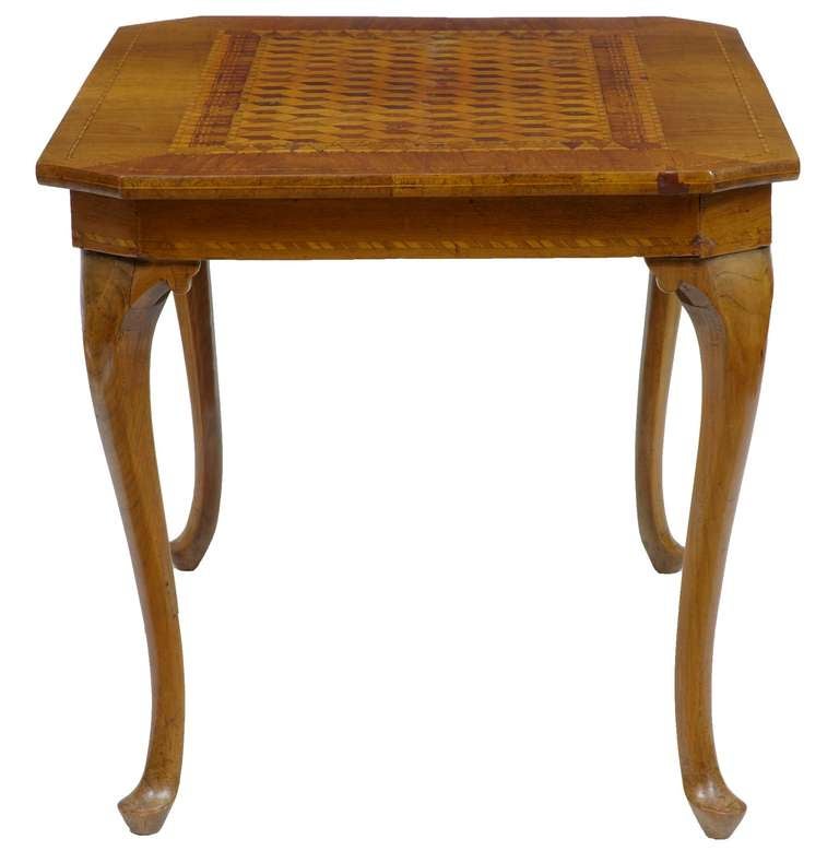 Beautiful table with a parquetry inlaid top, M C Escher like Design. 

Standing on cabriole legs.