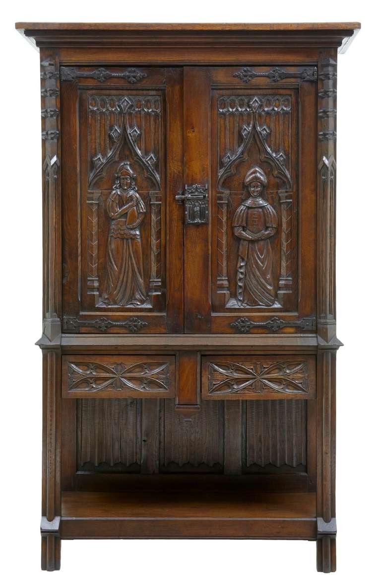 Here We Have A Beautiful Victorian Cupboard Using Earlier Carvings. 

Profusely Carved With Linen Fold And Tracery. 

Double Door Opens Up To A Single Shelf And Cupboard Space, Followed By 2 Drawers And A Potboard Below, Which Is Enclosed On The