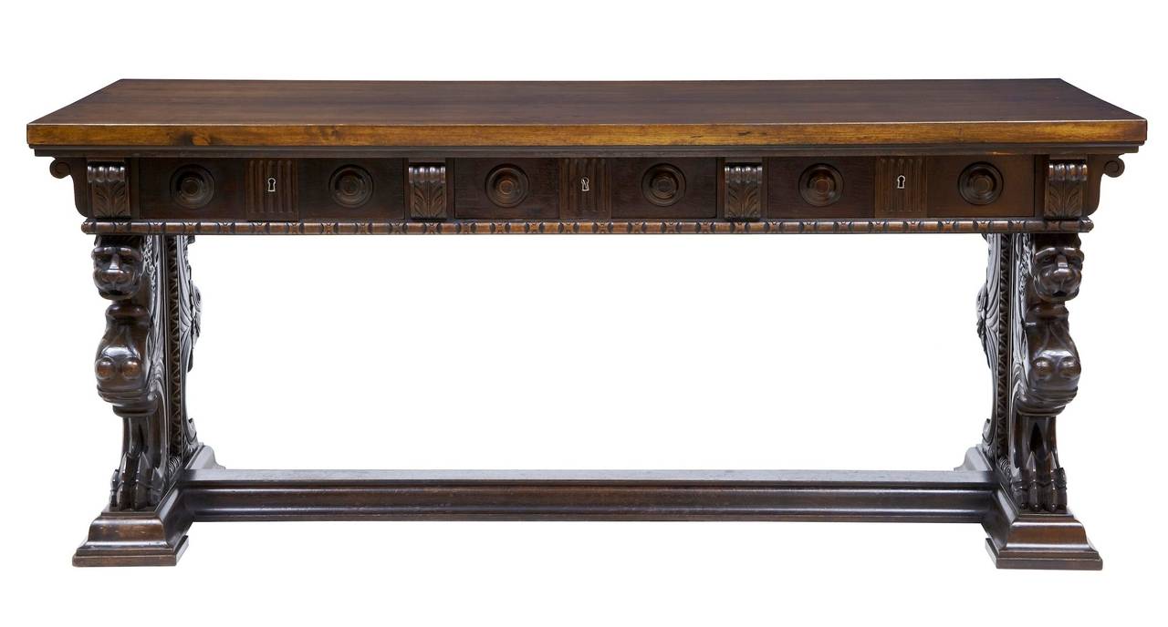Large carved walnut desk circa 1890. 

Typical Italian trestle ends depicting mythical beasts, united by stretcher. 

3 deep drawers with partitions.