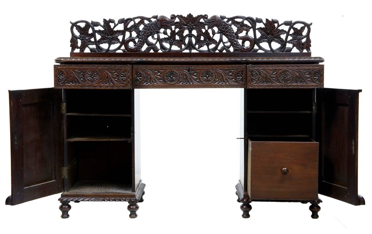 Stunning padouk anglo indian sideboard. 

Main feature is the pierced carved gallery back which shows fish and foliage. 

Pedestal piece which comprise of 3 parts, also the gallery is removable. 3 drawers in the top section. Sunburst carved