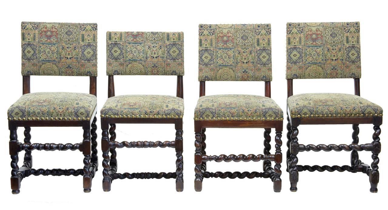 Large harlequin set of 12 chairs circa 1880. 

All uniformly upholstered in tapestry covering, described as a harlequin set as the chairs are mostly all slightly different, either in back height, carving or stretcher positioning. 

Measurements
