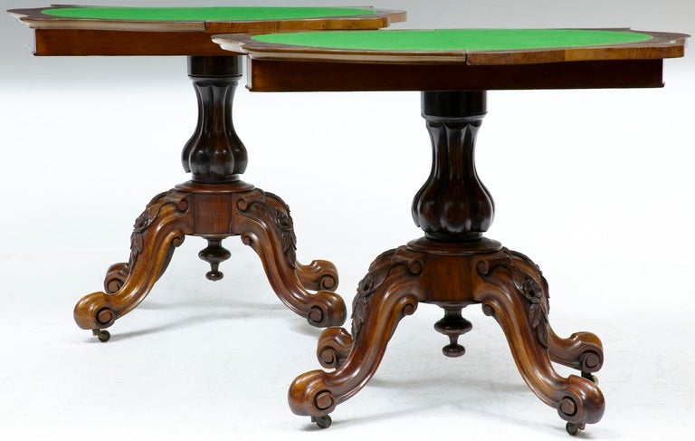 HERE WE HAVE A STUNNING PAIR OF PEDESTAL CARD TABLES.

SERPENTINE FORM WITH FOLD OVER FLAP AND STORAGE WELL UNDERNEATH, 4 HIPPED CABRIOLE SUPPORTS WHICH ARE CARVED WITH LEAF AND FLOWERS, STANDING ON BRASS CASTORS.

GREEN BAIZE IS TOOLED ROUND THE