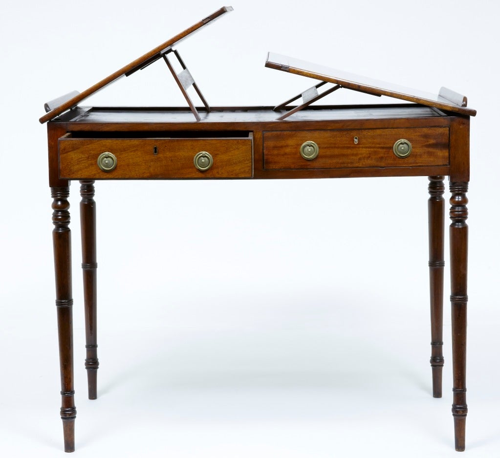 19TH CENTURY ANTIQUE MAHOGANY DOUBLE SIDED READING TABLE<br />
<br />
WITH ONE DRAWER EACH SIDE AND ONE DUMMY, WITH TWO ADJUSTABLE READING SLOPES ON EACH SIDE