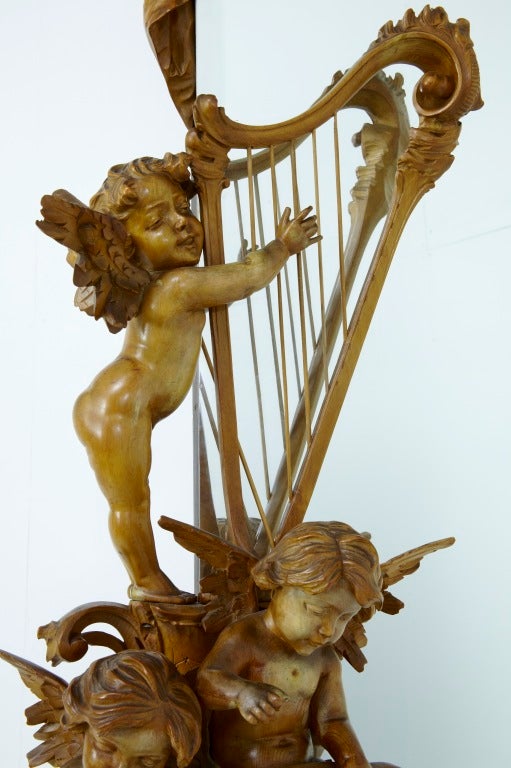 Late 19th century antique carved wood cherub cheval mirror

Beautiful floor standing cheval mirror, adorned with superbly carved cherubs studying and playing musical instruments.

Very rare piece and in exceptional condition