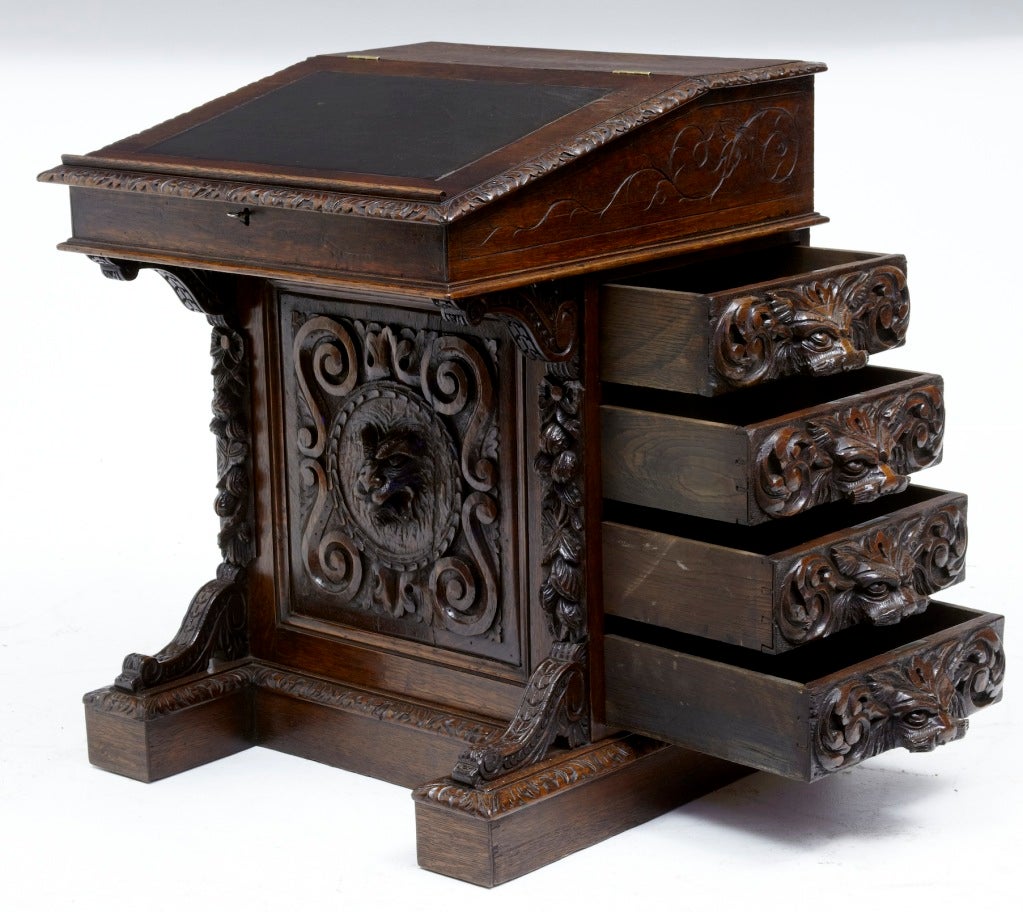 19TH CENTURY ANTIQUE CARVED OAK DAVENPORT

FEATURING 4 DRAWERS TO ONE SIDE WITH CARVED ANIMAL HEADS FOR HANDLES, BEAUTIFULLY CARVED ALLOVER, WITH ORIGINAL LEATHER TOP, WHICH OPENS UP TO REVEAL OAK INTERIOR.