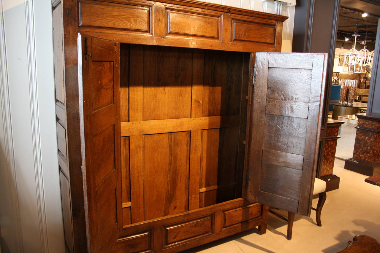 Large Louis XVIII cupboard, early 19th century. Oak body with sliding iron locks. This piece was found in a monastery in France.