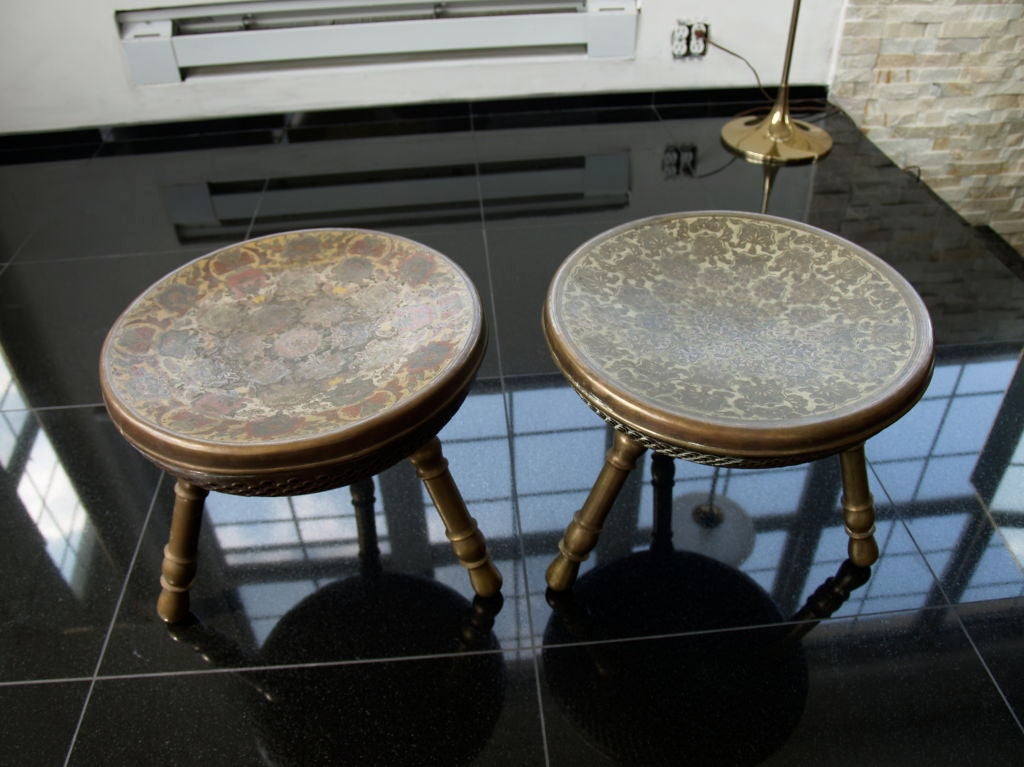 3 brass foot warmers with a wonderful aged patina. they can be used as foot rests or seats. they are the same size, with different artwork etched into the brass tops. they look great next the the fireplace or off to the side of a coffee table.