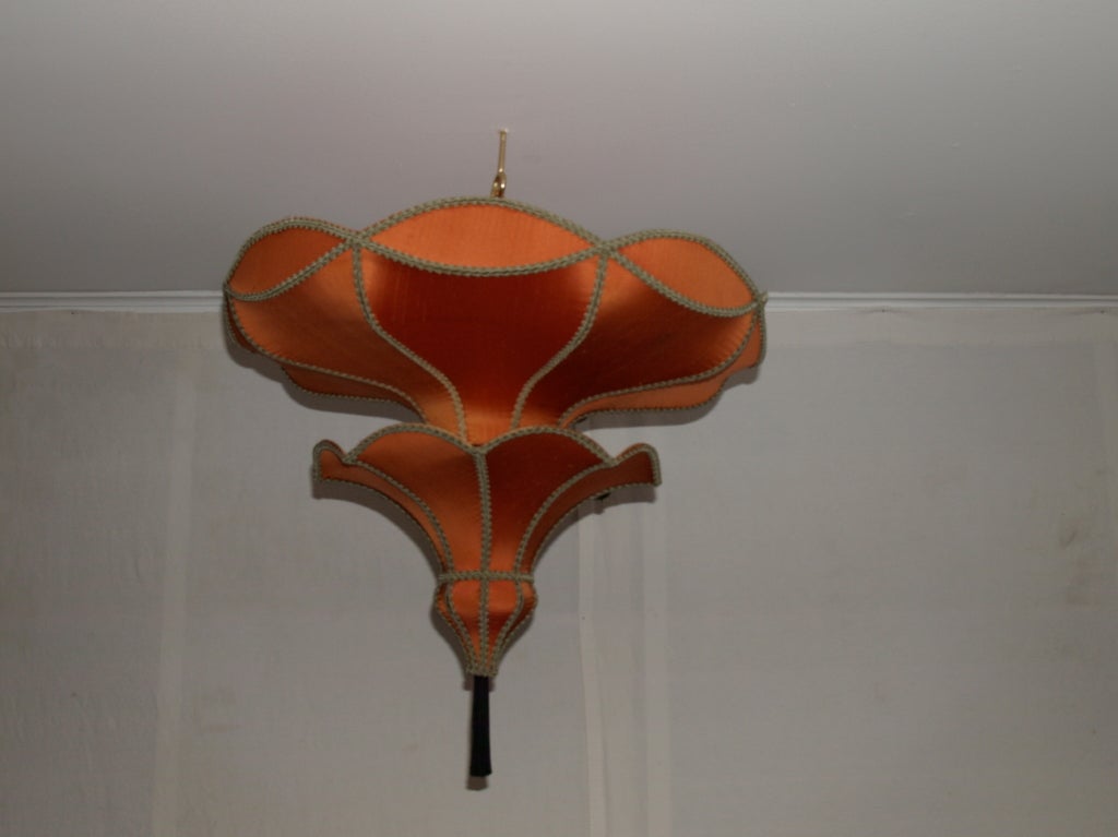 this is a great lamp to soften up that room with the high ceilings.<br />
Has a Moroccan feel to it. <br />
it is constructed of a wire frame with a raw silk fabric stretched over the fame.<br />
antique victorian details along the edge.<br