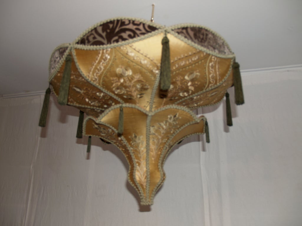 this is a wonderful hanging light that really will soften up any room.
great for high ceilings. it is in very good condition.
the colors are sage green and gold. it is made of silk and cut velvet stretched over a wire form.