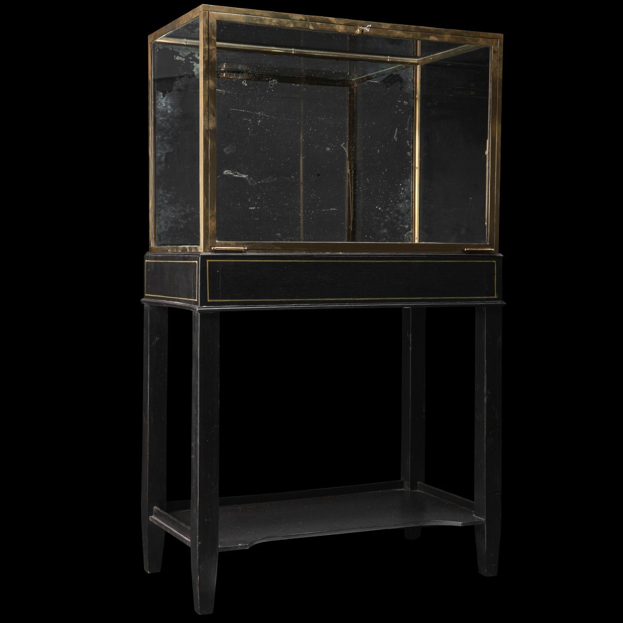 Brass display cabinet with original glass panels on ebonized base. 

Made in England circa 1880.