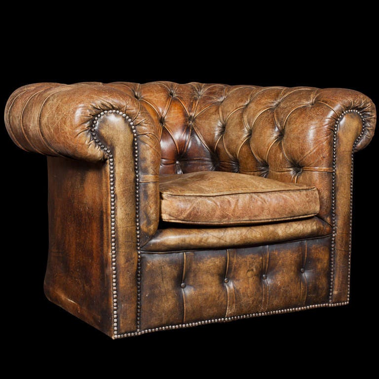 Strong proportion, original leather, tufted roll around arms
