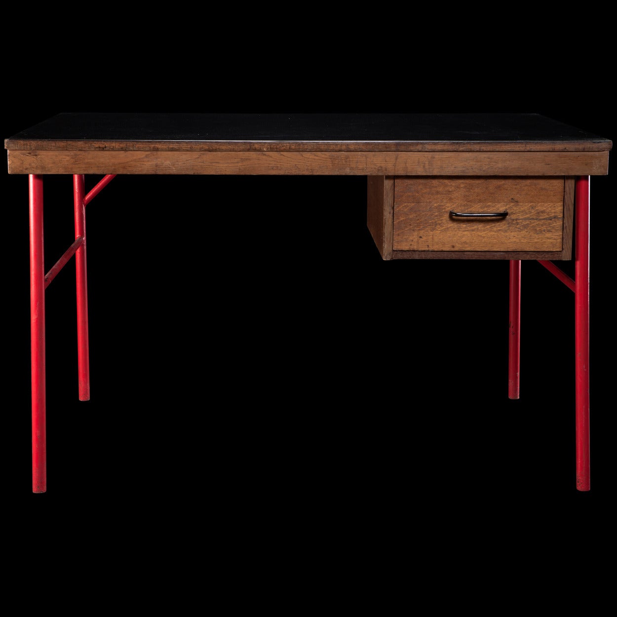 Simple modern desk, solid wood table top with black formica surface on red metal base.

Made in France circa 1960.