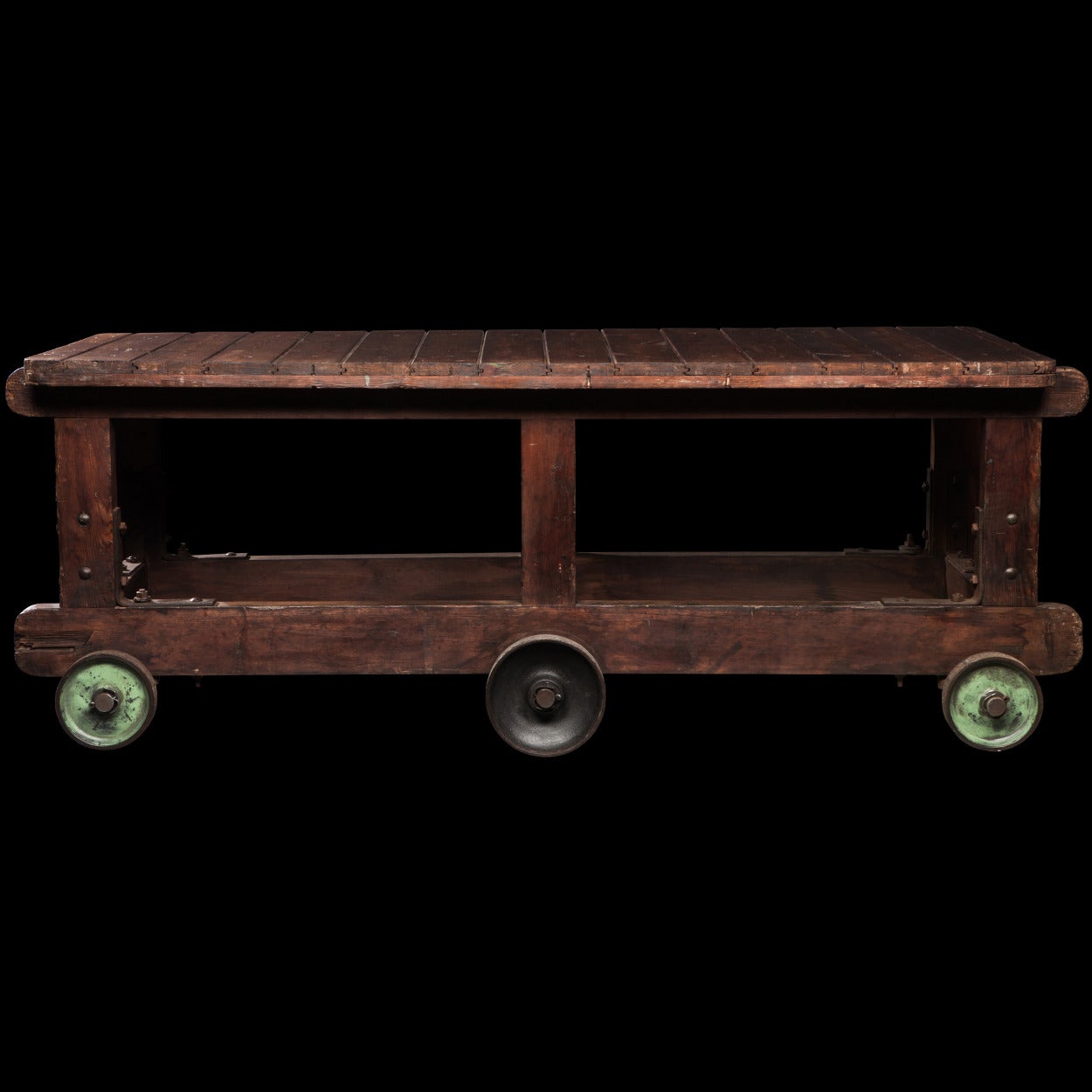 Oak trolley cart with planked top and original green painted iron wheels.

Made in England circa 1910.