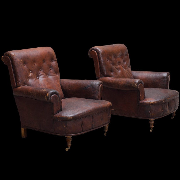 Simple roll arm, tufted back chairs, original leather.