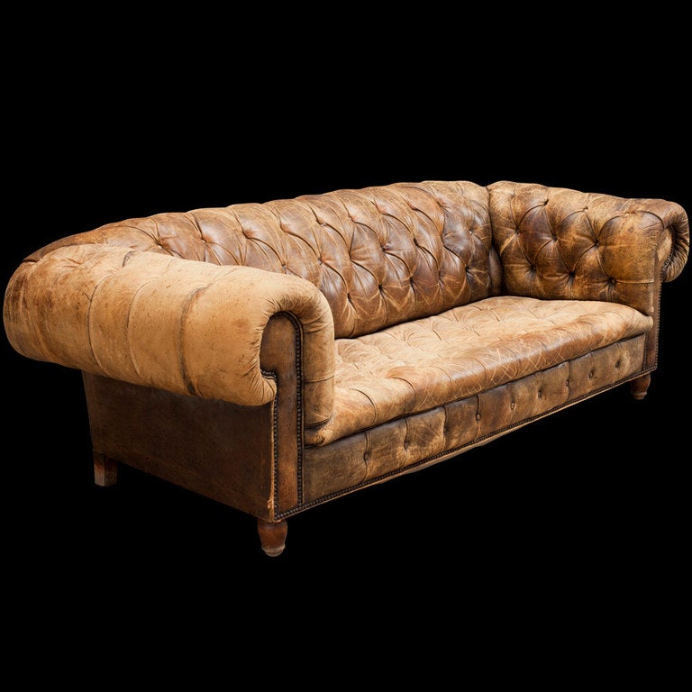 Extraordinary tan distressed leather sofa with roll arms, wood feet.