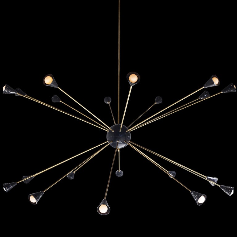 20 black punched metal shades, connected to brass rods and a single black dome