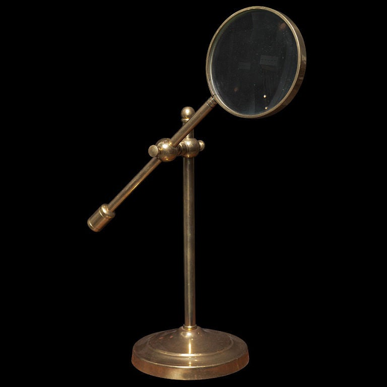 Large magnifying lens on brass adjustable stand.