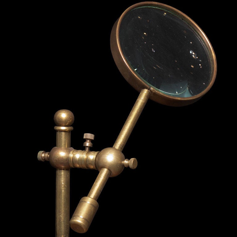 brass magnifying glass on stand