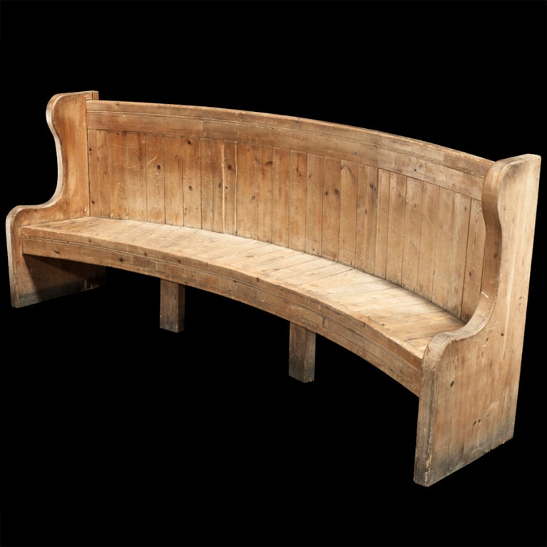 Substantial bench with eight legs, curved form.