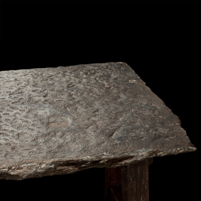 Primitive table with stone slab top and wood frame base