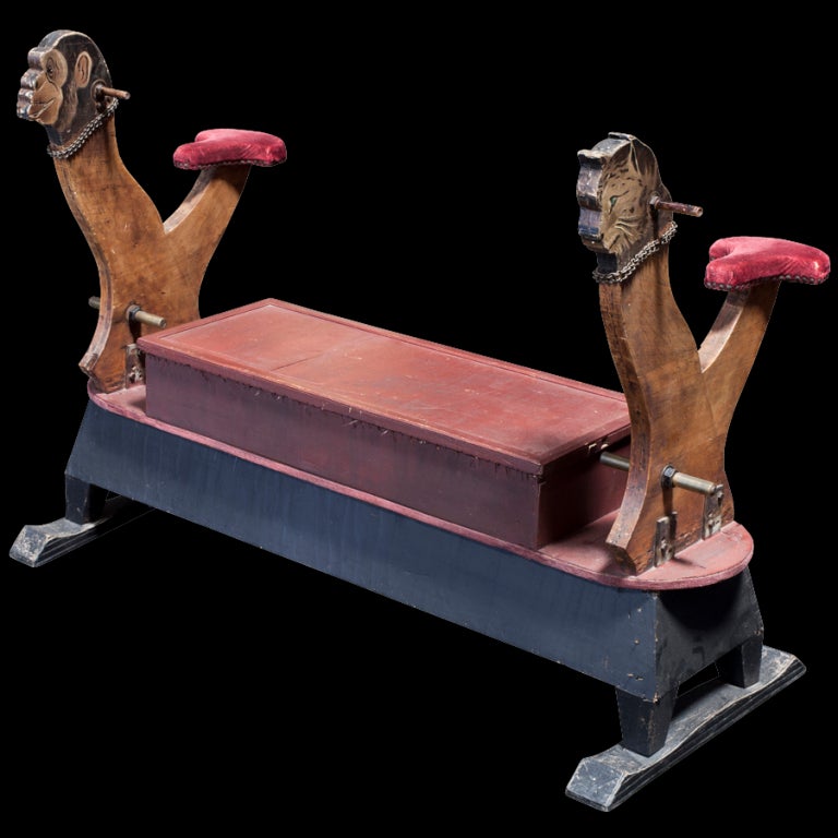 wonderfully constructed bench with riding posts of a monkey and a cat, velvet seats