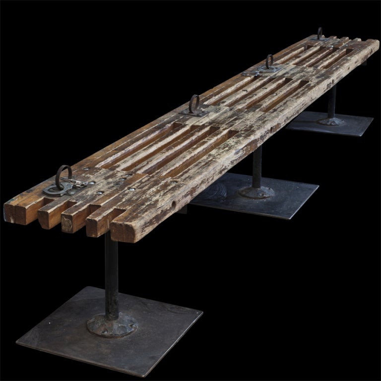 Community prison holding bench, slatted oak bench with four iron hand cuff placements