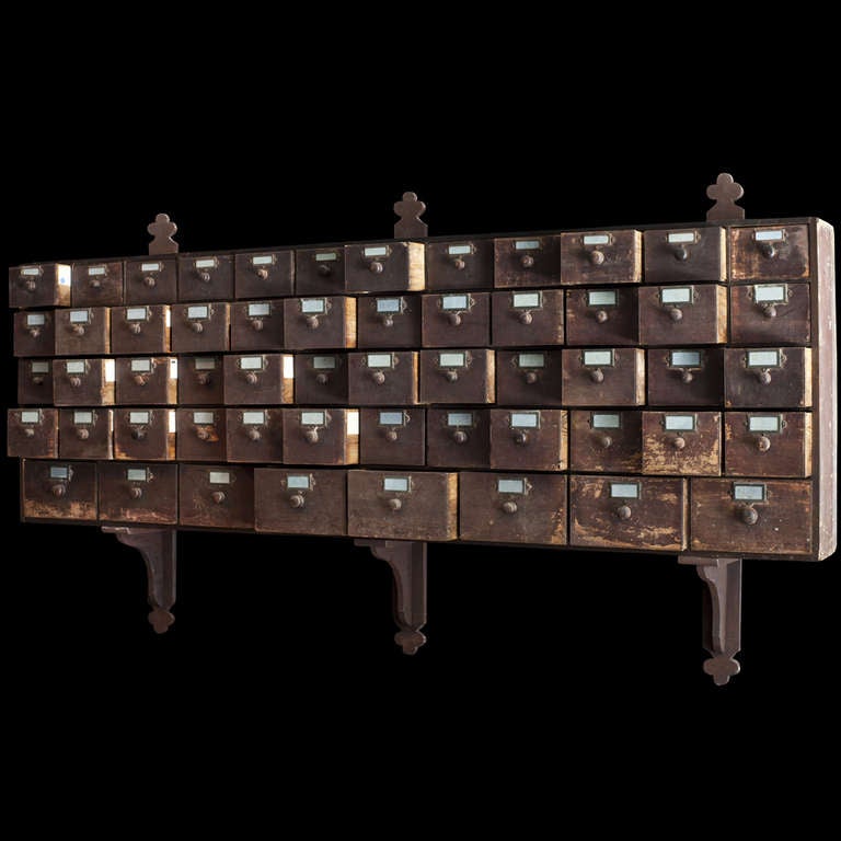 Large Bank of Wall Mounted Seed Drawers original hardware, painted surface.