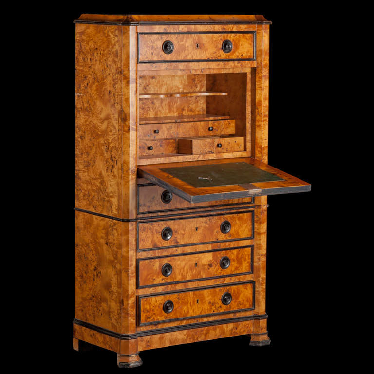 Burl maple chest, with ebonized moulding. 

Upper drawers hide a drop down desk with original green leather insert, and compartmentalized storage.