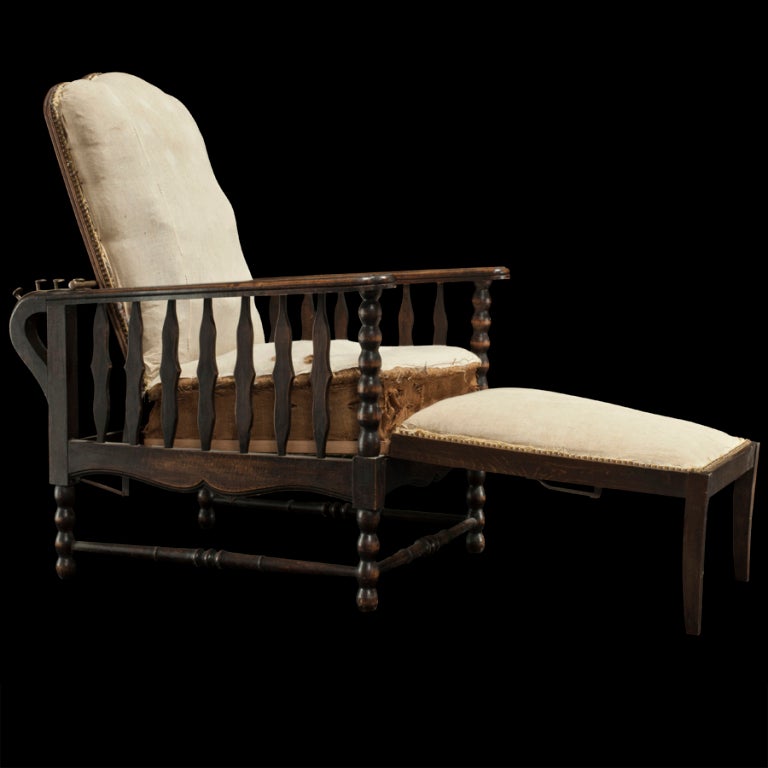 Unusual lounge chair stripped down to the original upholstery , interesting hidden ottoman