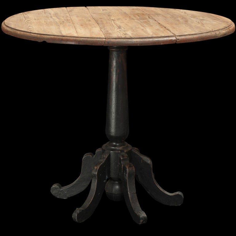 Large round center table with unusual black painted base/ feet