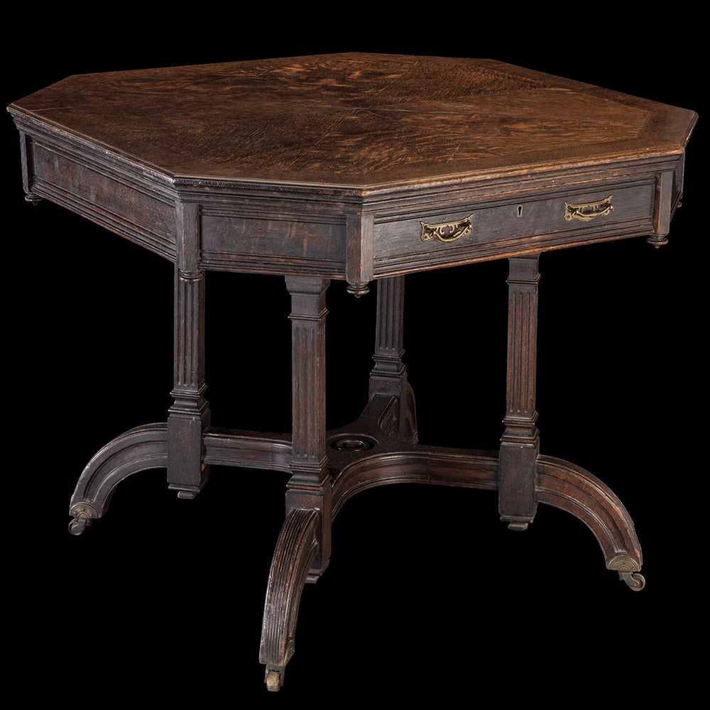 Octagonal oak center table with two drawers and original brass hardware.