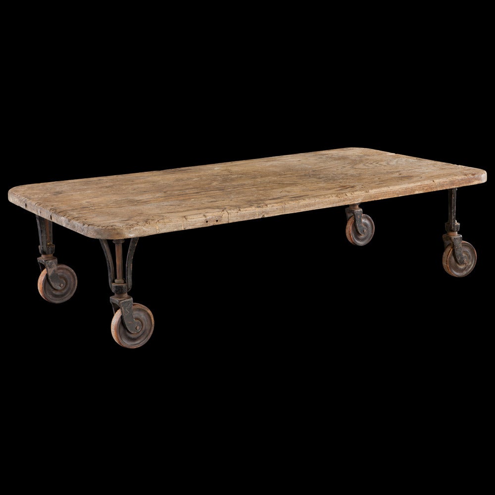 Coffee table with original Industrial metal and wood castors.