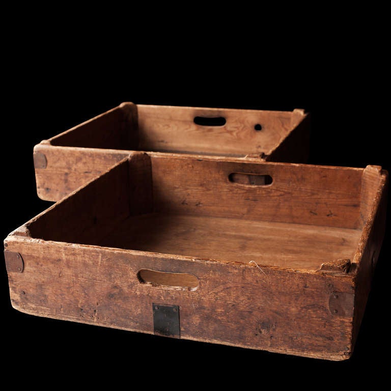 Handcrafted box with carved handles, supported corners, simple form
  