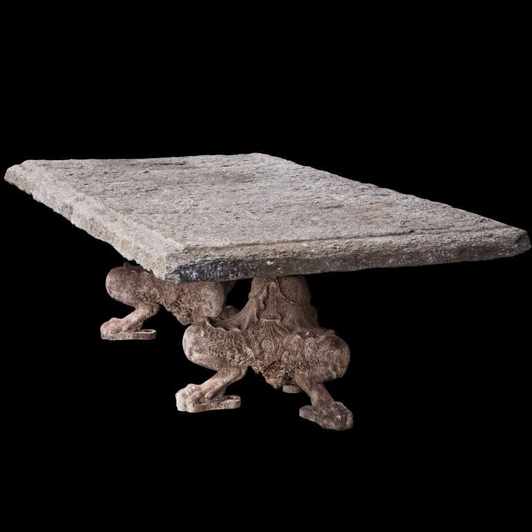 Massive stone table with cast iron lion claw feet holding up the massive stone top