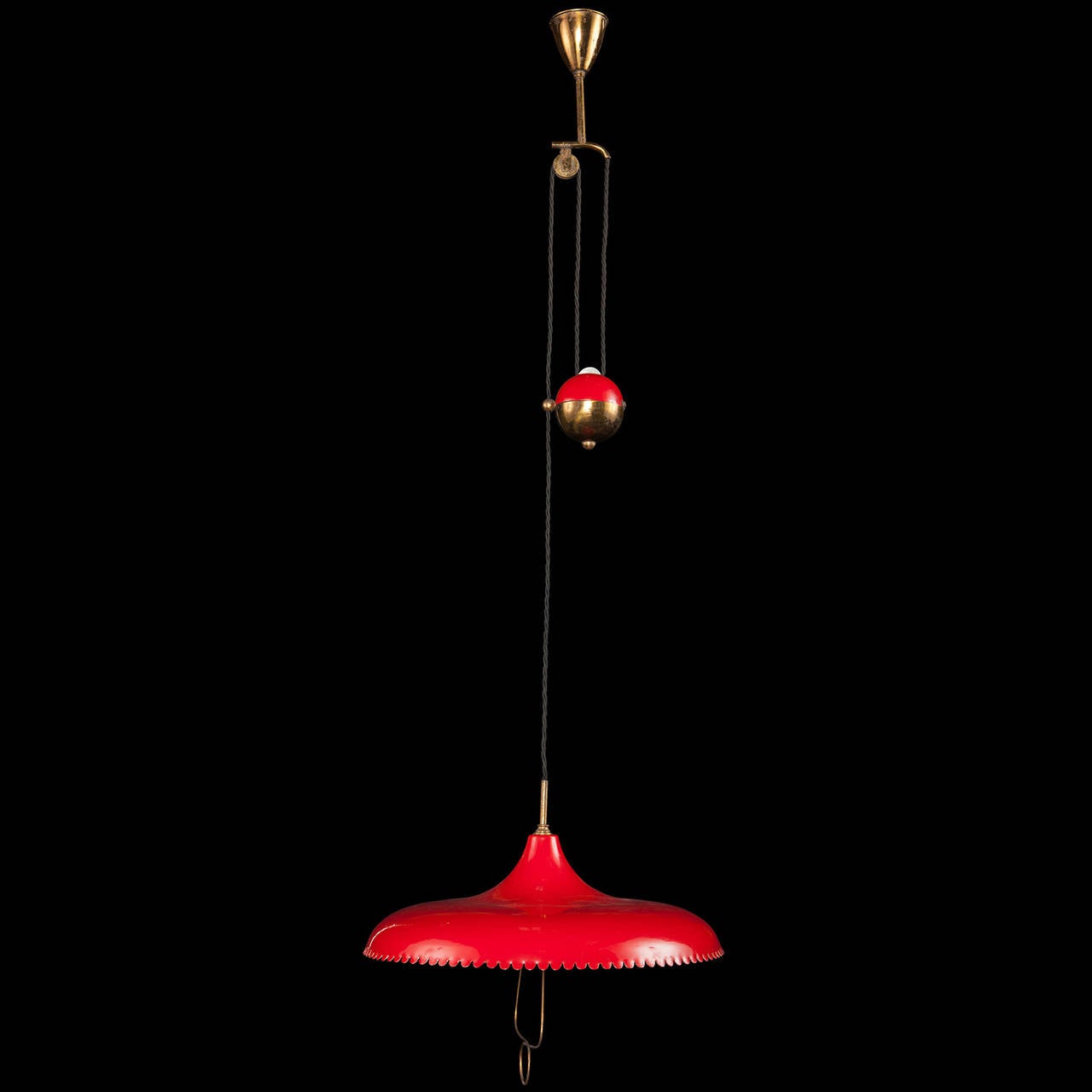 Brass canopy with red lacquered shade and counterweight allowing adjustable height.