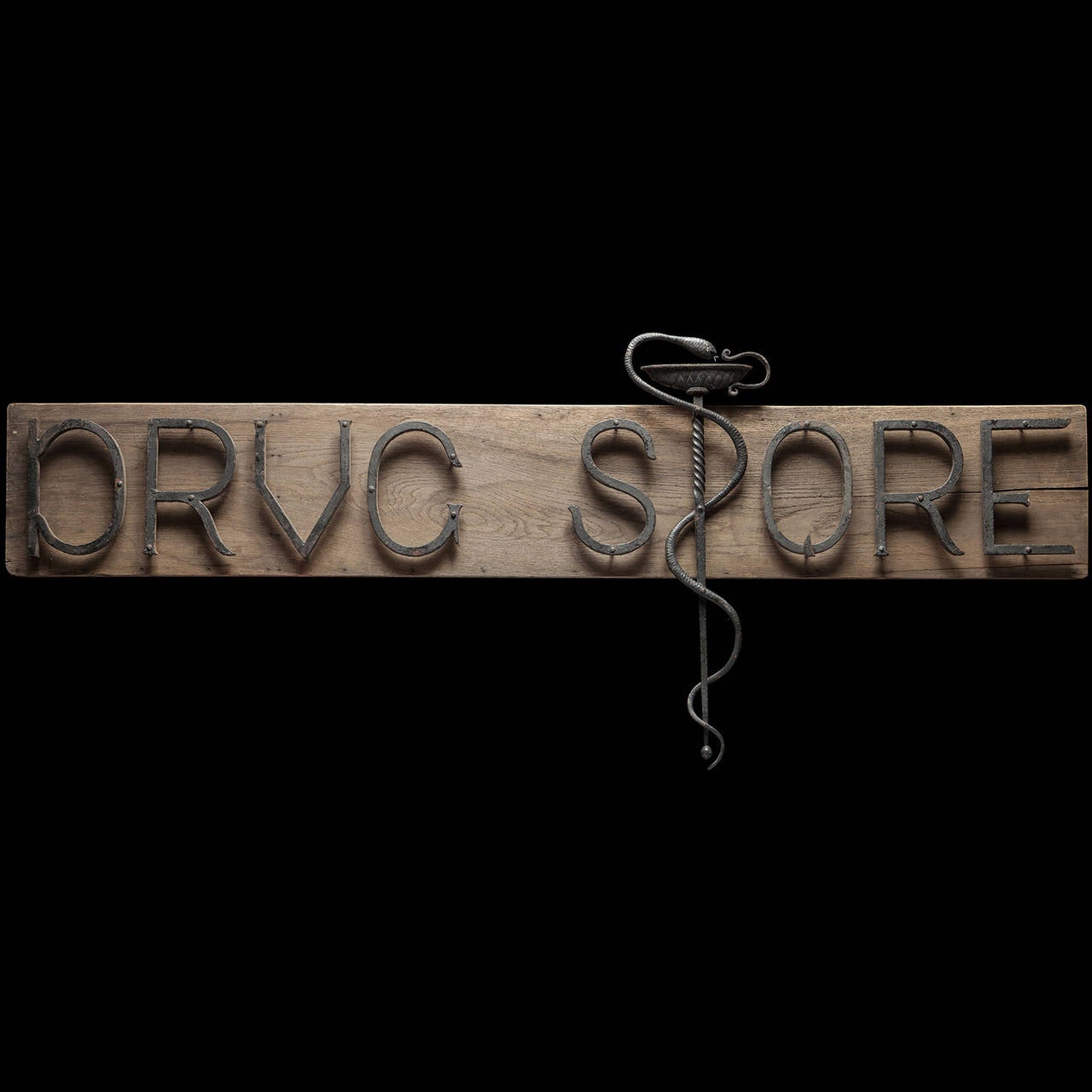 Solid steel letters on an oak board. The serpentine “S” represents the Rod of Asclepius; a common symbol used by medical organizations.