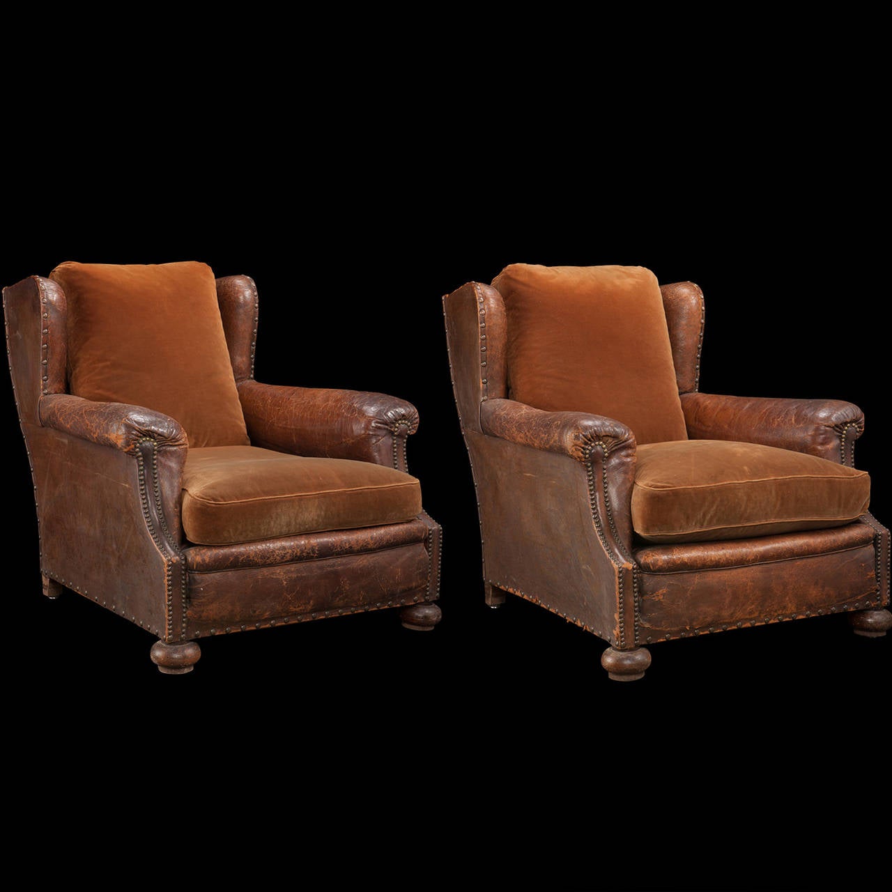 Leather upholstered body, fitted with brass nails on oak bun feet. Upholstered in velvet.
